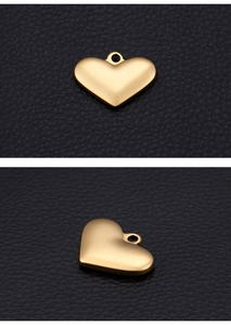 Detailed view of two gold-finish heart pendants with smooth surface and small top loop