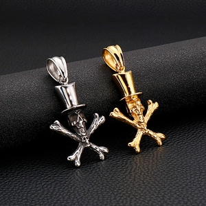 Punk style skull and crossbones pendants in gold and silver finish on black background