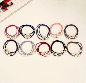 Close-up of high-elasticity hair ties with white pearls and gold beads in 10 colors