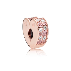 Macro shot of rose gold heart charm with pink crystals and engraved side details