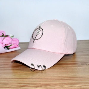 Detailed view of pink cotton baseball cap with silver rings and a number 5 metal pendant