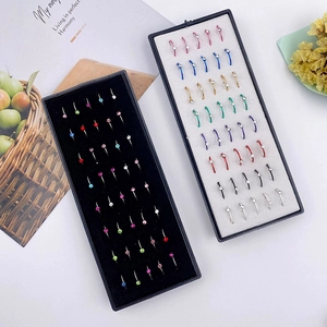 Macro detail of multicolored stainless steel nose rings with small crystals in a display box