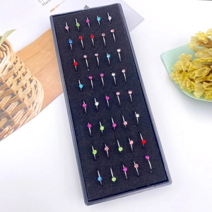 Detailed top view of 40-piece colorful crystal stainless steel nose rings in a storage box