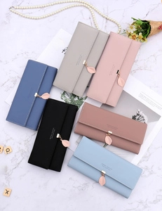 Detail view of long envelope wallets with leaf pendant in six elegant matte colors