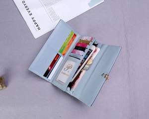 Detailed interior of a light blue long wallet showing card slots and phone pocket