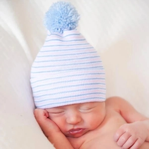 Detailed close-up of double-layered newborn beanie with blue stripes and pom-pom