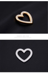 Detail of gold and silver heart-shaped pendants with pavé set sparkling cubic zirconia stones