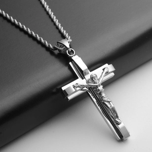 Detailed close-up of a silver titanium steel cross pendant with crucifix on a rope chain