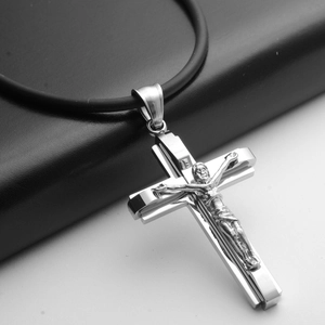Detail of multi-layered titanium steel cross pendant with Jesus on black rubber cord