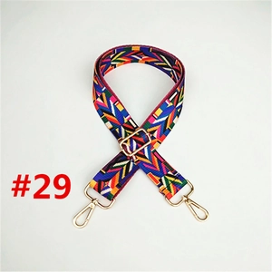 Close-up of multi-color geometric ethnic strap with premium gold metal swivel snap hooks