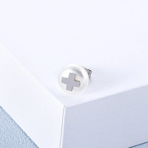Elegant white pearl stud earring featuring a silver cross motif on a white pedestal