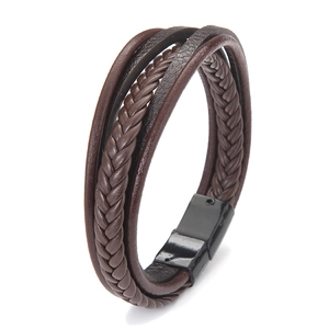 Close-up of brown multi-layer braided leather bracelet with black magnetic clasp detail