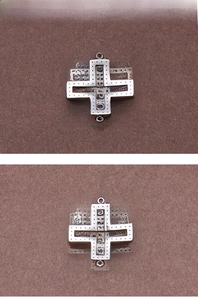 Detail of silver hollow cross pendant with rhinestones and dual connector loops