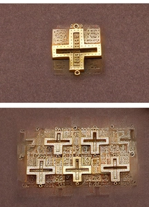 Close-up of five golden hollow cross pendants with sparkling zircon stone inlay