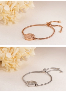 Detail of adjustable Hamsa hand bracelets with snake chain and sliding clasp in rose gold and silver