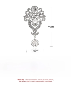 Detailed view of silver crown brooch with crystal accents and 9cm by 5cm size dimensions