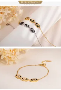 Detail of geometric rectangle gold and silver bracelets with black enamel chain links