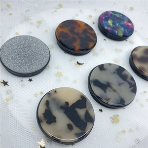 Various stylish cell phone grip designs including tortoiseshell and marble patterns