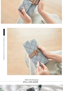 Detail of light blue PU leather wallet with floral embossing and brown strap buckle