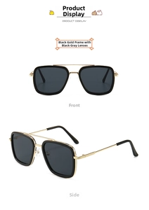 Detail of square black and gold metal sunglasses with double bridge and dark lenses