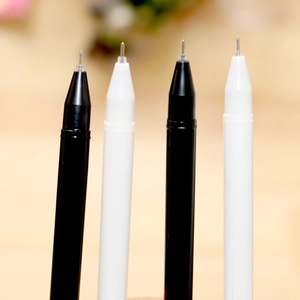 Set of four creative cat claw gel pens in black and white colors on a warm desk
