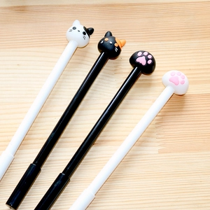 Cute cartoon cat and paw gel pens in black and white set on a wooden surface