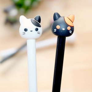 Close-up of black and white cartoon cat paw designs on cute plastic gel ink pens