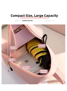 Detail showing pink mini backpack interior with phone, power bank, and essentials