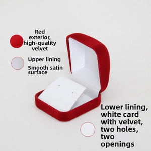 Macro detail of red velvet earring box with dual-hole white satin lining and soft padding