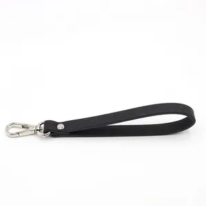 Close-up of black cross-grain leather wrist strap with polished silver metal hook