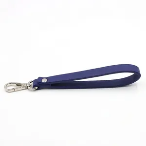 Detail view of navy blue crosshatch leather wristlet strap with silver lobster clasp