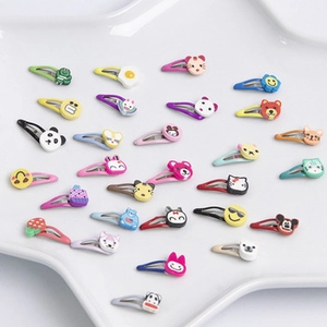Flat lay of colorful 2.5cm BB hair clips with cartoon shapes on white tray
