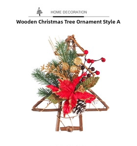 Close-up of wooden Christmas tree ornament with pine needles, berries and poinsettia flower