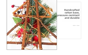 Detail of handmade wooden rattan wreath base with pine needles and red berries decor