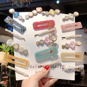 Close-up of pastel acetate and pearl hair clip set displayed on a white product card