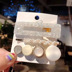 Detailed set of 3 elegant hair clips featuring pearls and floral acetate designs