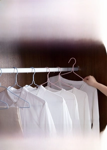 Detail view of anti-slip dipped hangers for wet and dry clothes hanging in a wardrobe