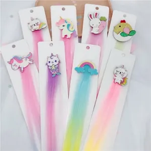 Close-up of assorted colorful unicorn and rainbow hair clips with long gradient extensions