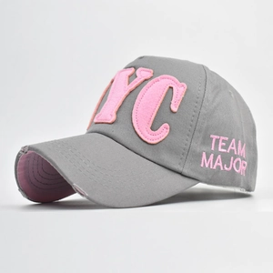 Close-up of NYC pink felt patch and distressed brim on the grey cotton baseball cap