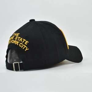 Detail showing the adjustable metal buckle and yellow NYC embroidery on black cotton cap