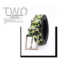 Detail of neon green leopard pony hair belt with gold buckle and smooth texture