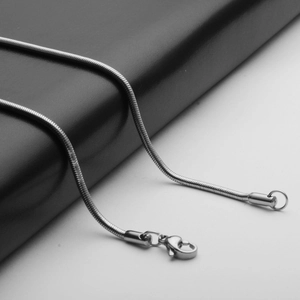 Detailed macro view of silver stainless steel snake chain with durable lobster clasp