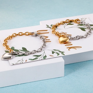 Two-tone heart charm bracelet in gold and silver stainless steel with polished finish