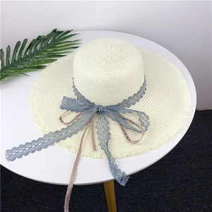 Beige wide-brim straw sun hat with grey-blue lace ribbon and fringe edges for women
