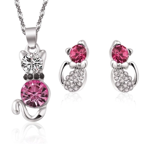 Silver cat jewelry set with pink crystal necklace and matching studs on white background
