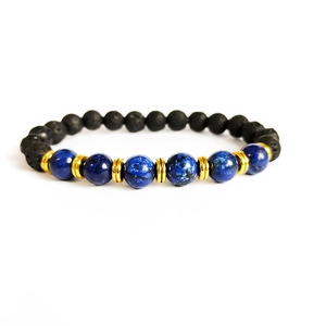 Detailed macro view of 8mm black lava stone and blue beads with golden spacers on a bracelet