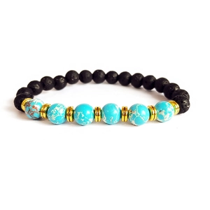 Detail of lava rock beads and turquoise stone bracelet with golden metal spacers