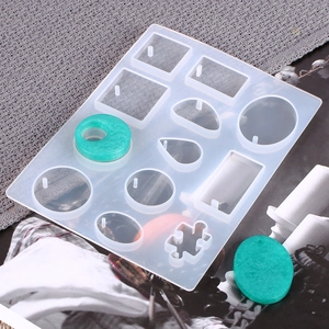 Silicone resin mold for DIY jewelry with water drop and square shapes on gray fabric