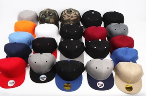Matrix display of colorful flat brim snapback caps in various solid colors and camouflage