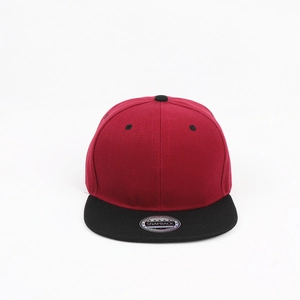 Close-up of red and black snapback hat showing high-quality twill fabric and peak sticker